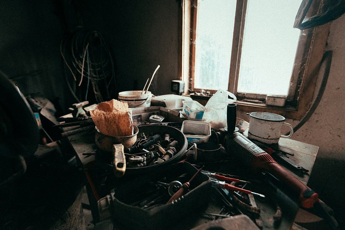 Tools and materials on a cluttered workshop bench
